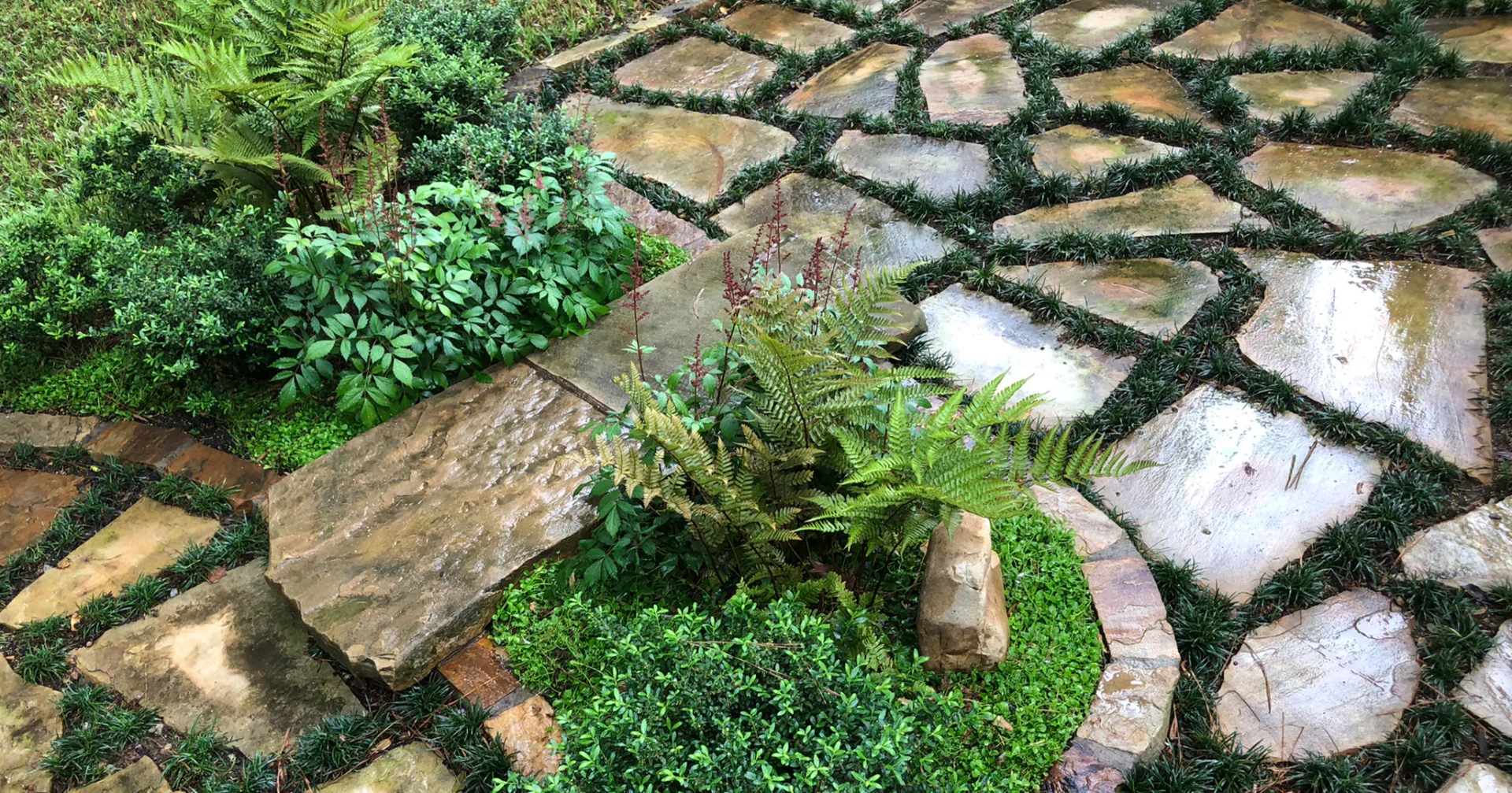 Patio stepping bridge through small garden